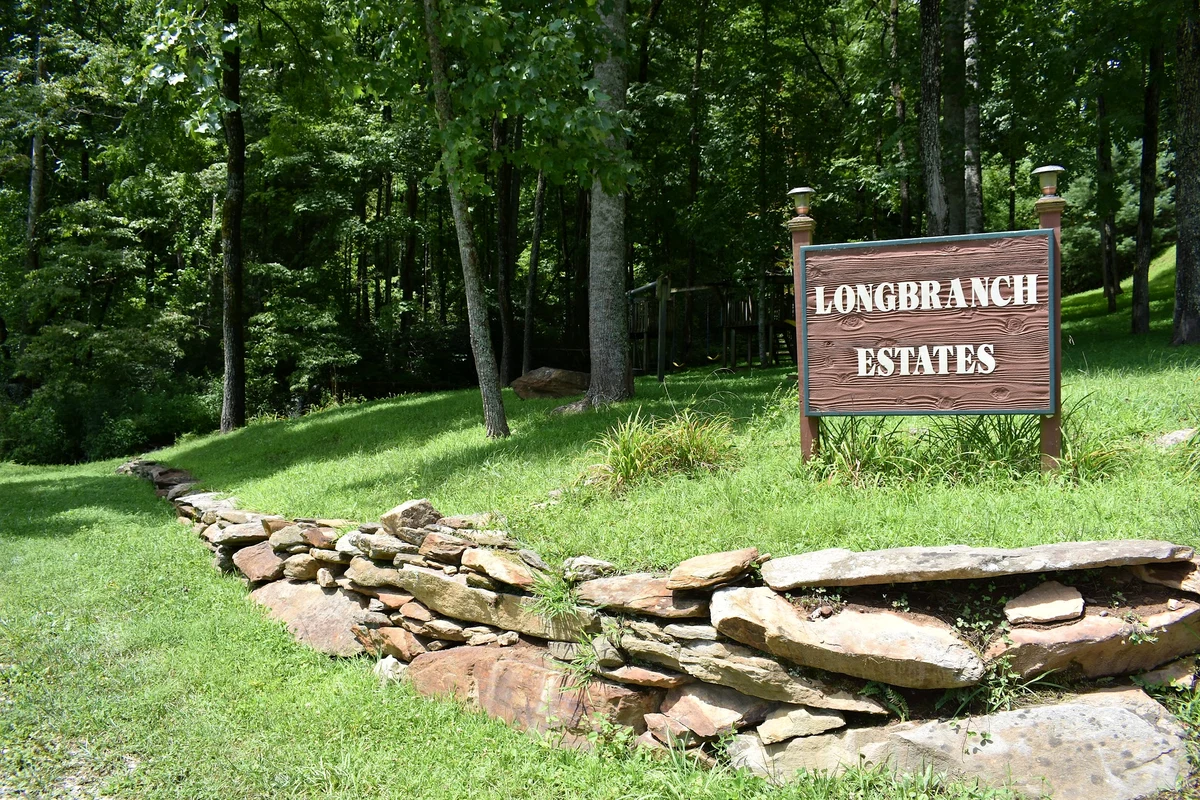 Long Branch Estates entrance sign beside woodland