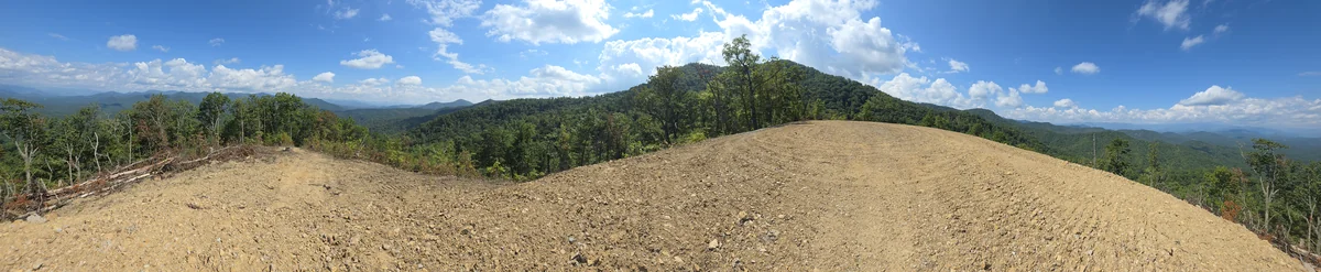 Lot 11 panoramic view: a wide photograph of the property and its surroundings