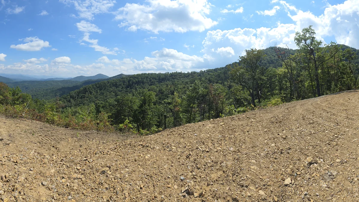 Forested ridgelines and hazy mountains from the Lot 11 photo stop
