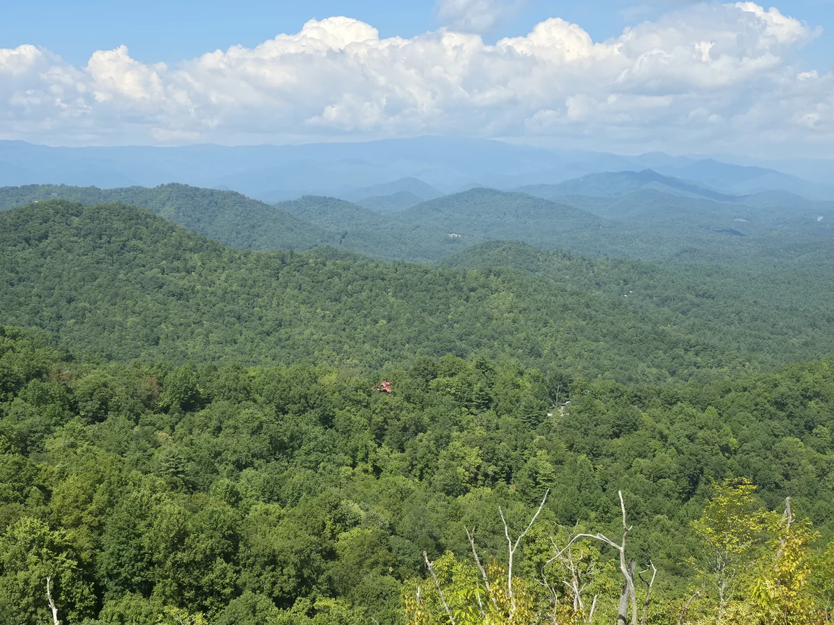 Forested slopes and distant ridges in an owner-supplied photograph labeled Lot 9